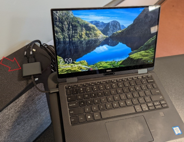 laptop with arrow pointing to the power cord adapter